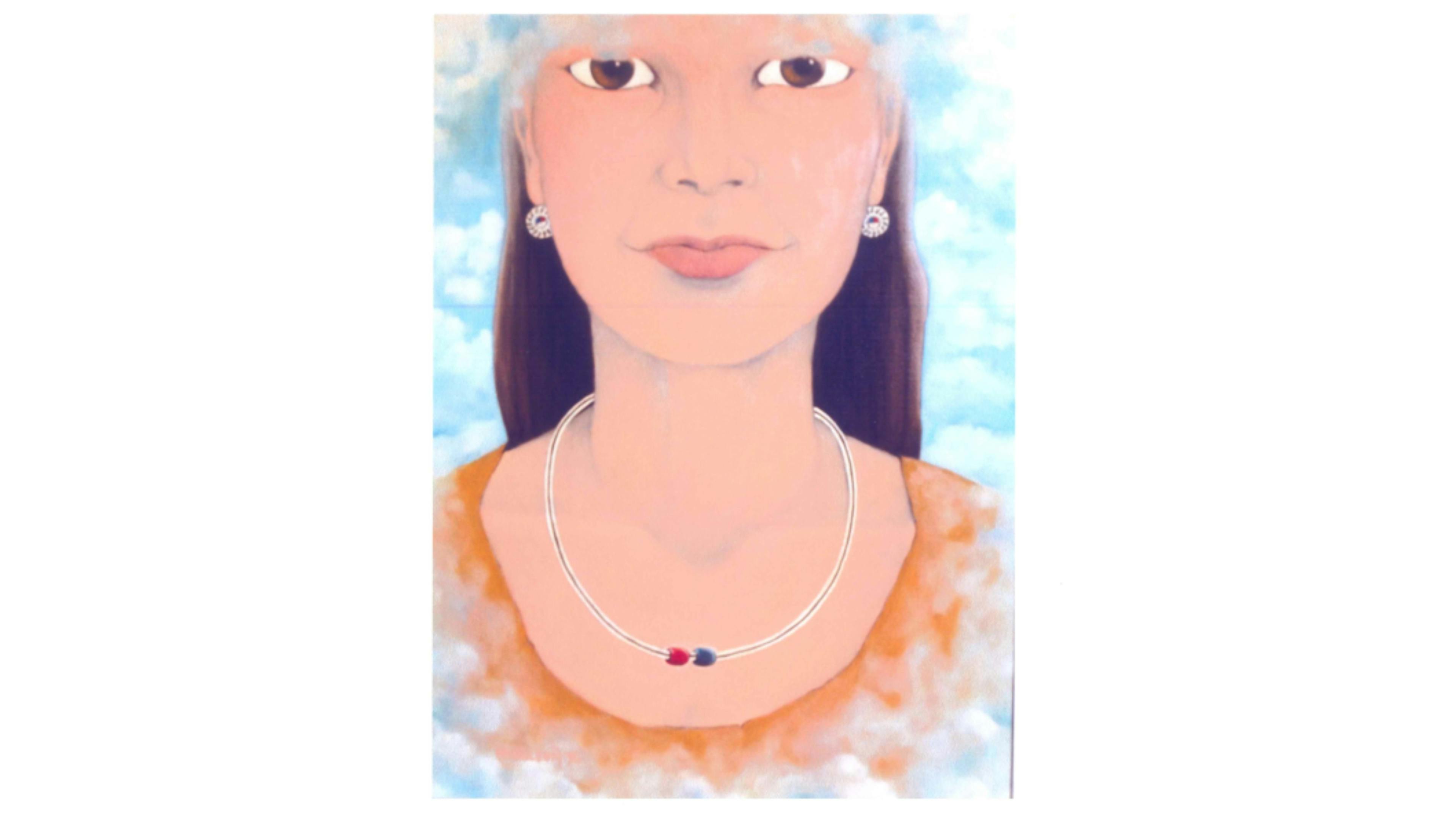 Portrait of a brown haired woman with brown eyes, zuni sun earrings and a necklace with one red bead and one blue bead in front of a blue sky background. 